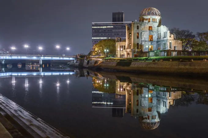 Genbaku Dome reflected in lake at night, Hiroshima, Japan.