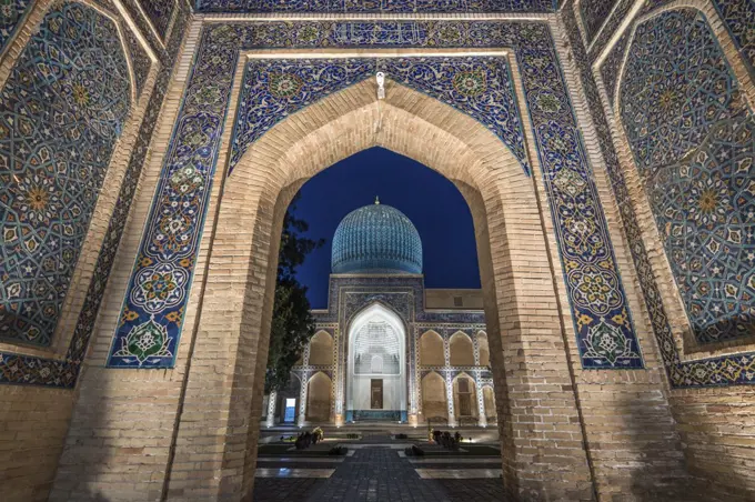 Archway inlaid with vibrant mosaic tile patterns, The Registan, a historic 15th century Madrasa building.