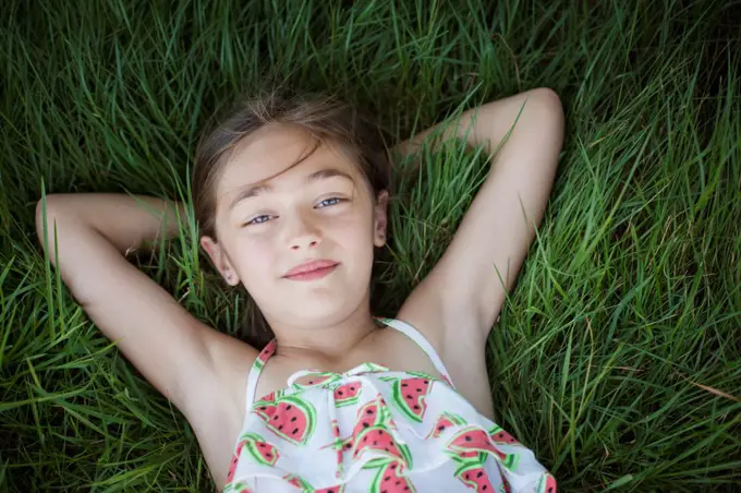 A child in the fresh open air on a sunny day, beside solar panels at a farm in New York State, USA. New York state, USA. 7/6/2012