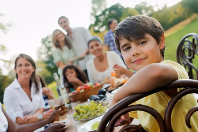 A family and friends having a meal outdoors.  A picnic or buffet in the early evening. Woodstock, New York, USA. 4/28/2012