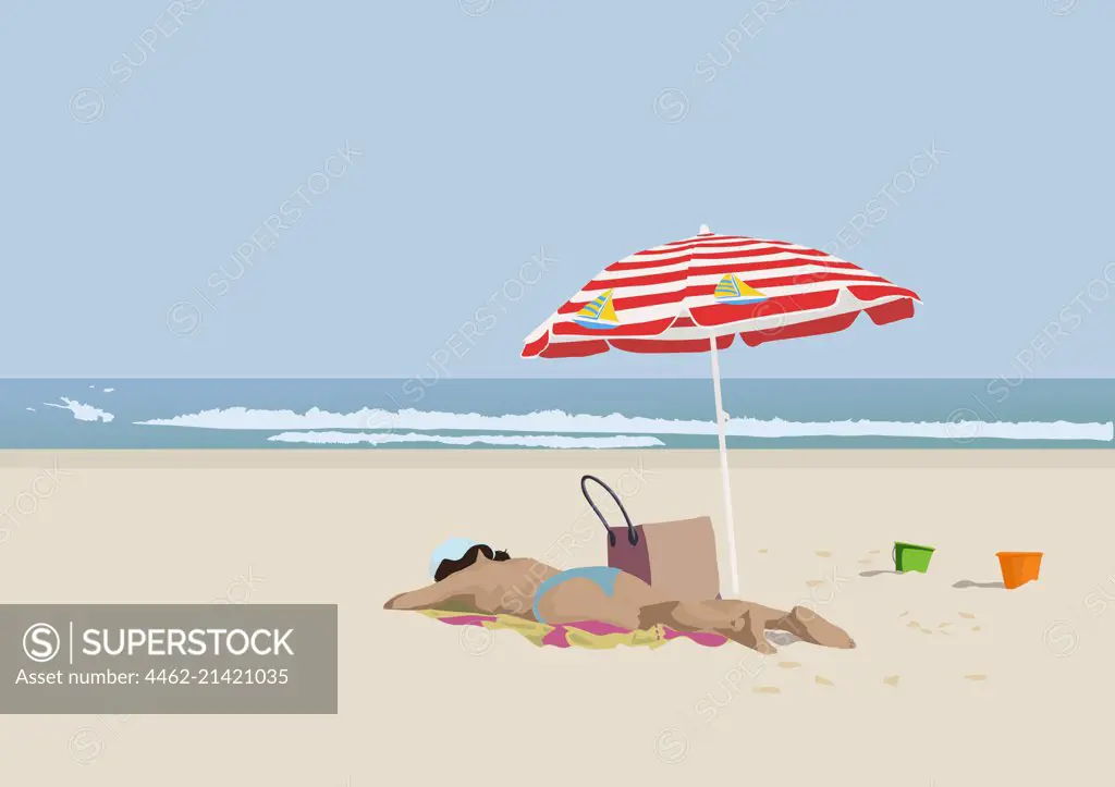 Woman sunbathing on sandy beach