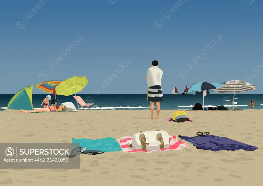 People on sandy beach, towels and sunshades