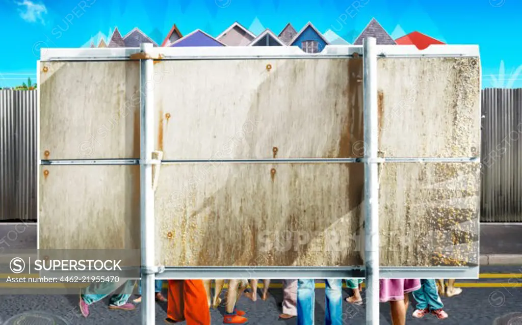 Large group of people standing behind billboard