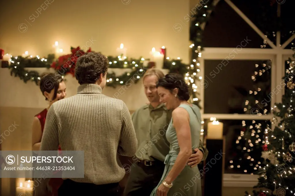 Group of mid-adult friends having fun at a Christmas party.