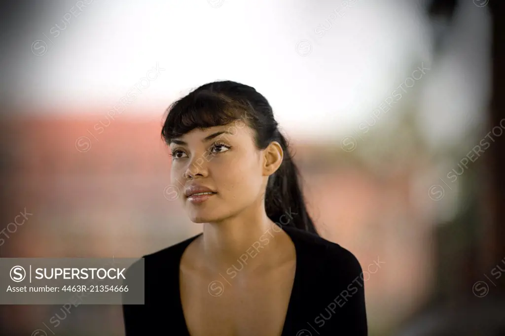 Portrait of a woman wearing a black dress.