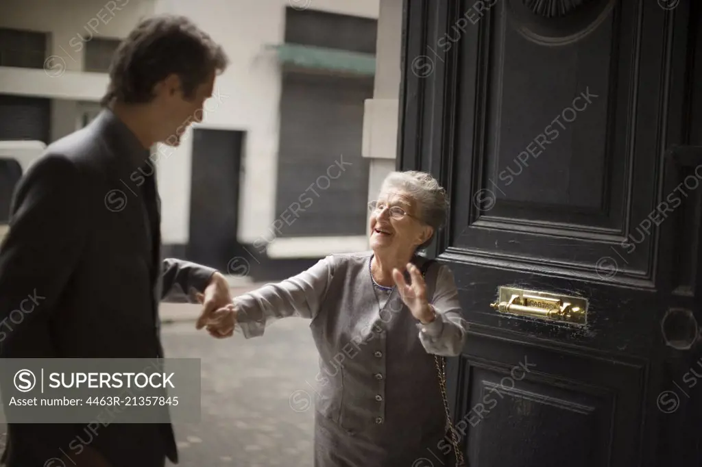 View of son holding his old mother's hand.