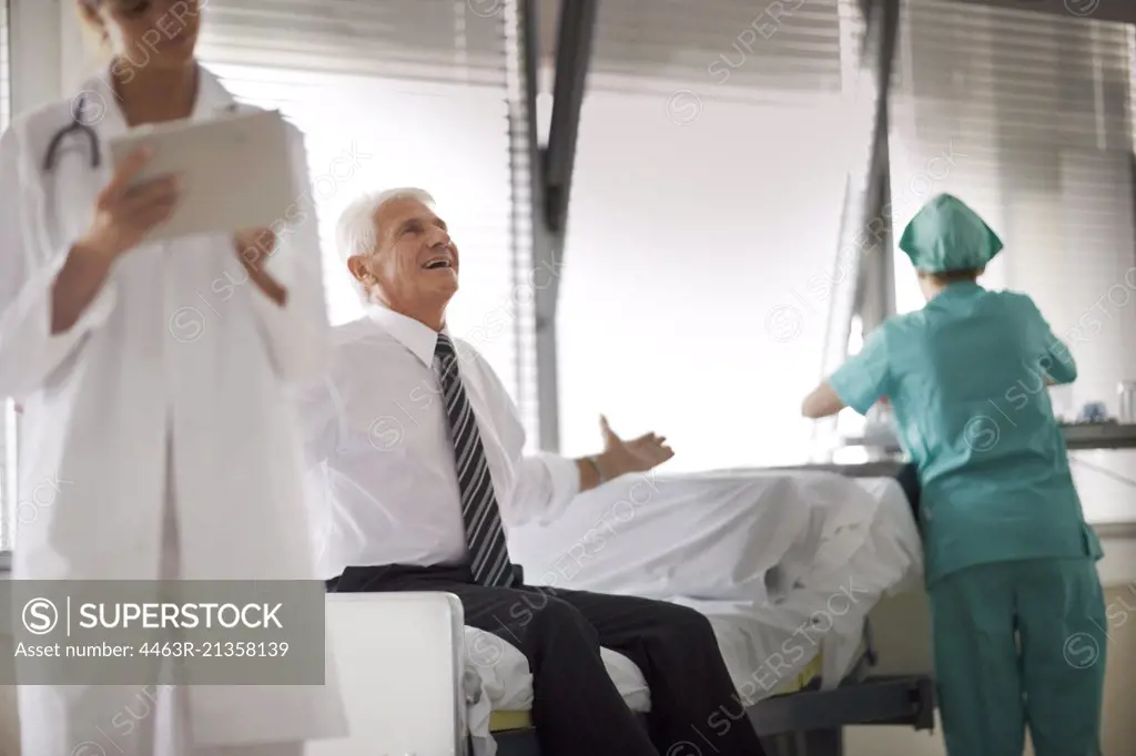 View of a man sitting on a bed with medical care.