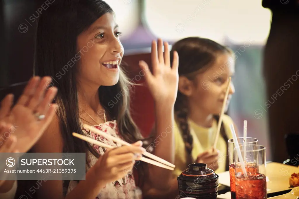 Two sisters at a teppenyaki restaurant.