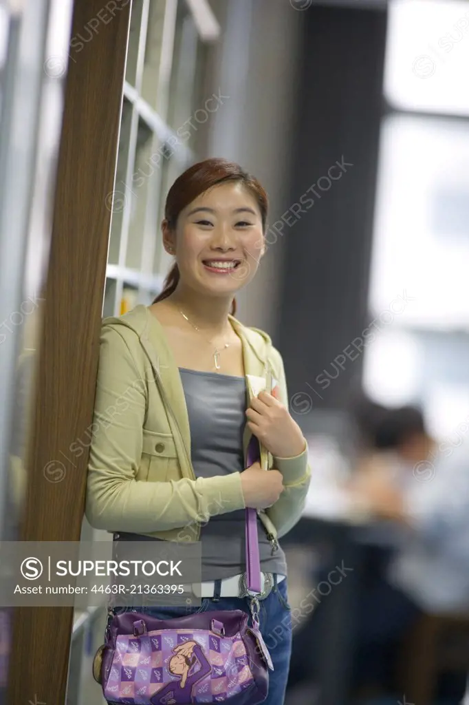 Portrait of a teenage girl in a library.