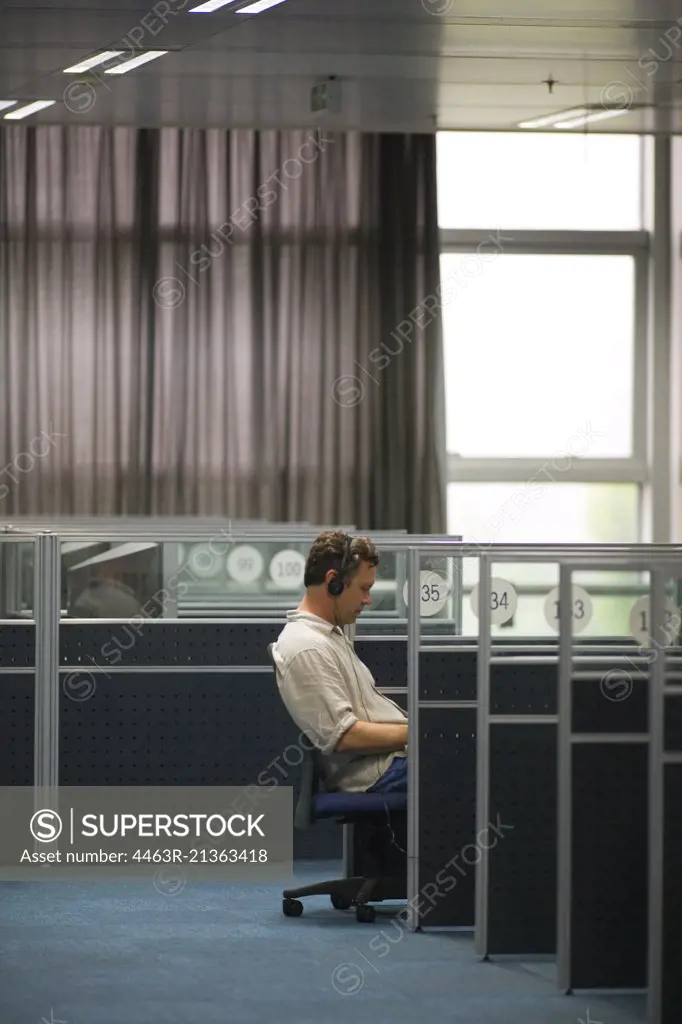 Teenage boy with headphones on in a television room.