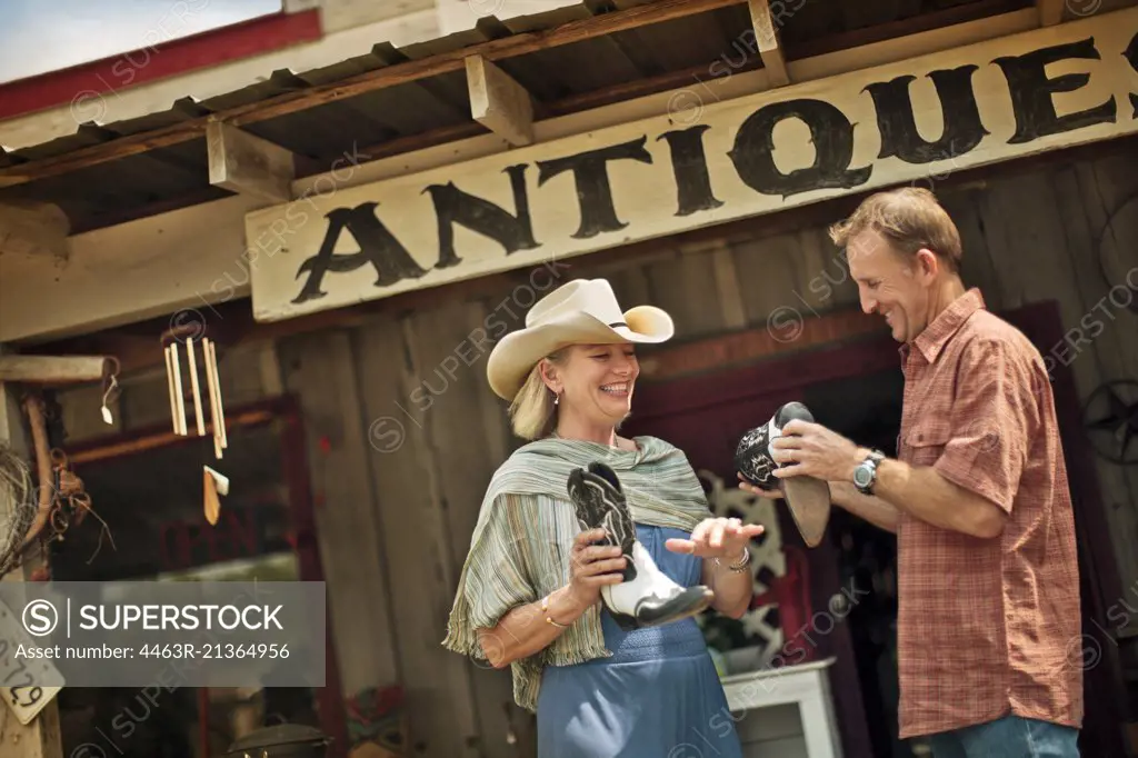 Smiling mature couple have fun shopping at the antique store together.