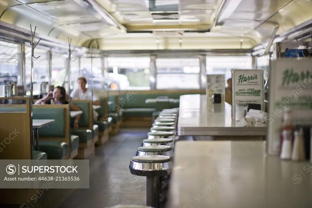 People sitting in booths in old fashioned diner