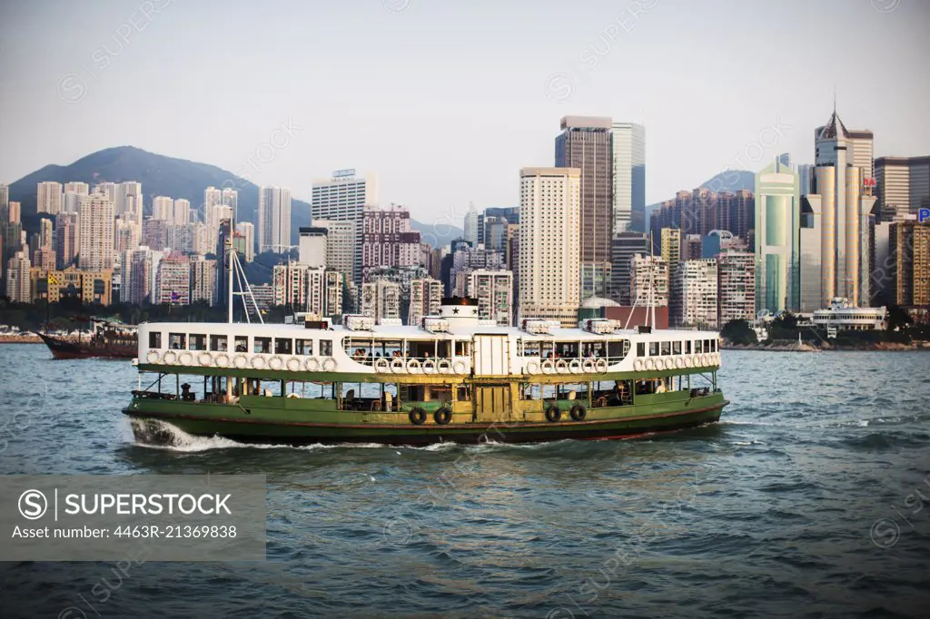 Ferry crossing the harbor of a large city.