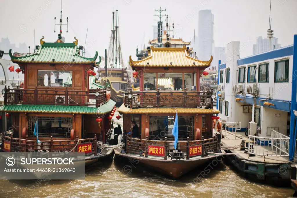 Traditional junk boat moored at a wharf.