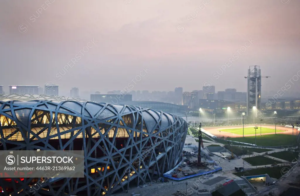 Illuminated sports stadium at night.