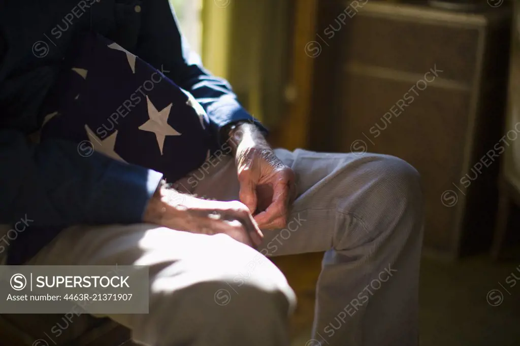 Senior man with a folded American flag