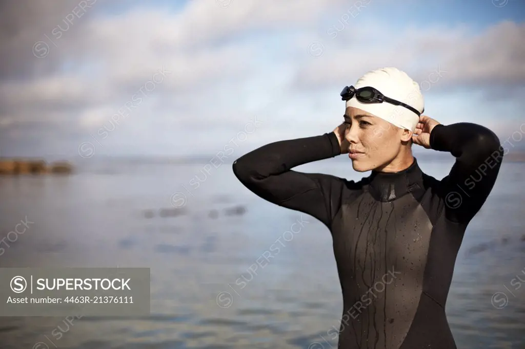 Young female athlete preparing to swim at the beach