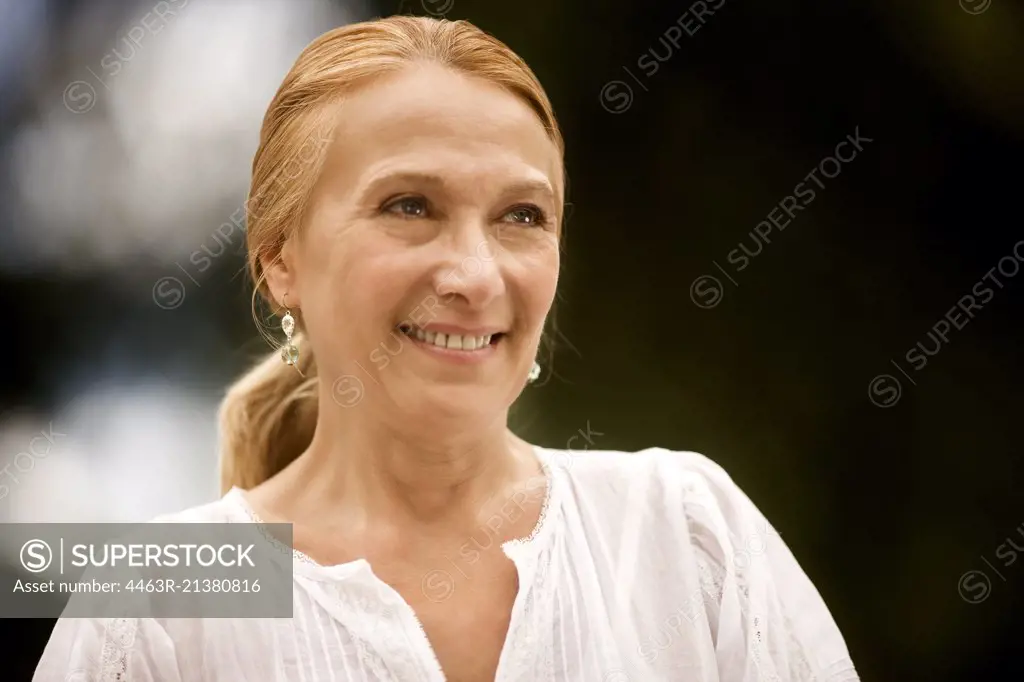 Portrait of an elderly woman outdoors.