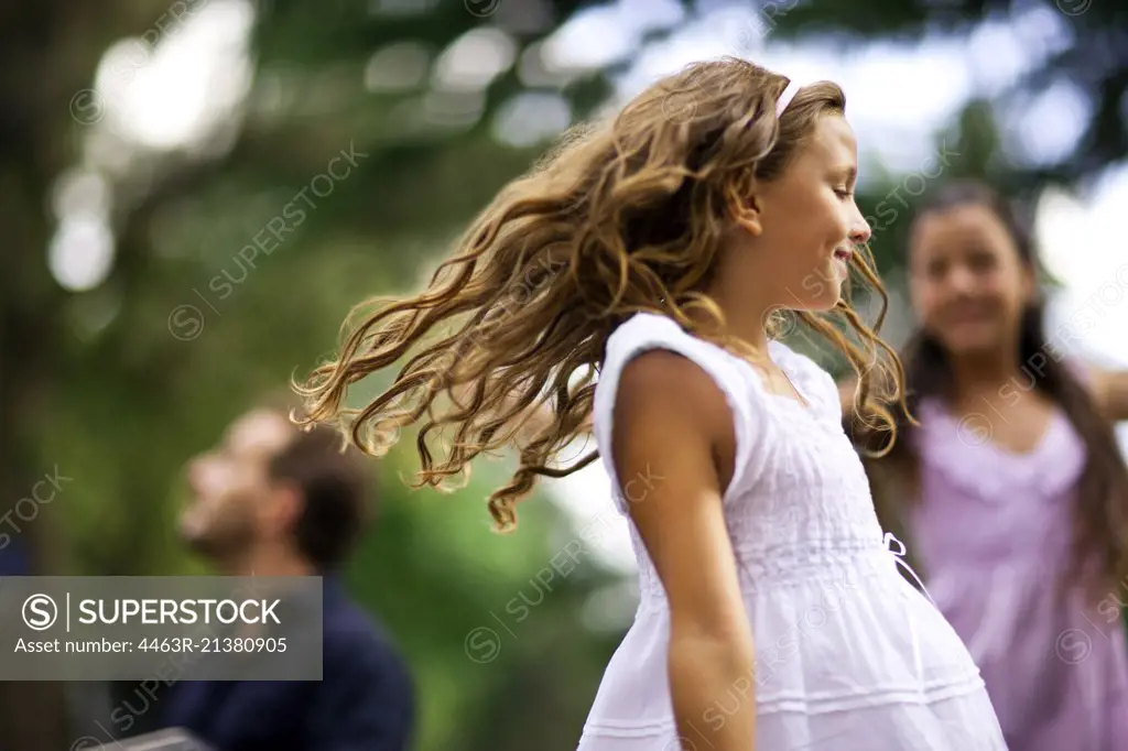 Young girls dancing outdoors.