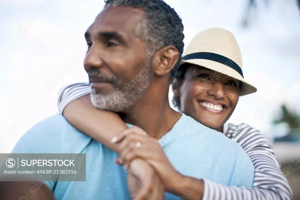 Mature couple lovingly sitting together. 