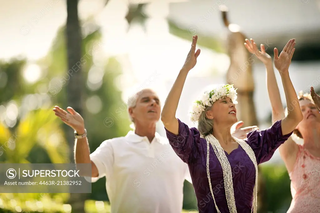 Mature woman teaching the hula dance.