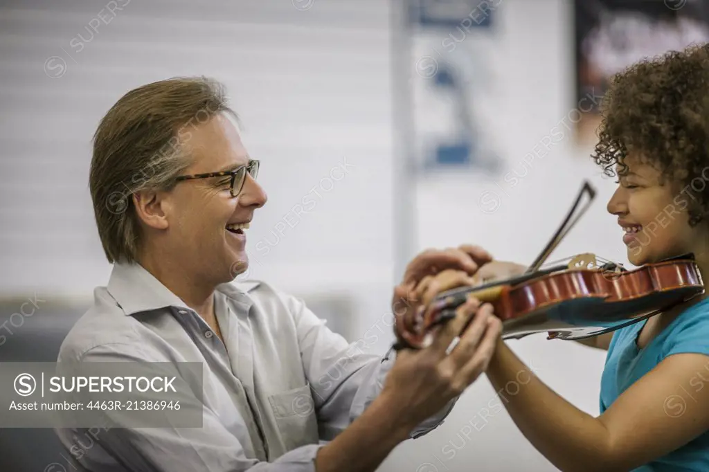 Teenage girl learning to play violin.