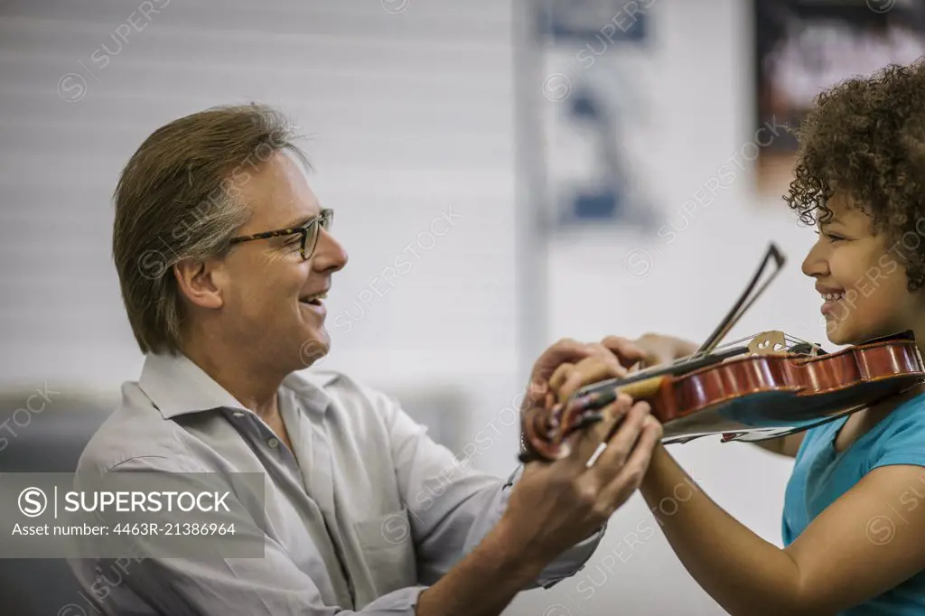 Teenage girl learning to play violin.