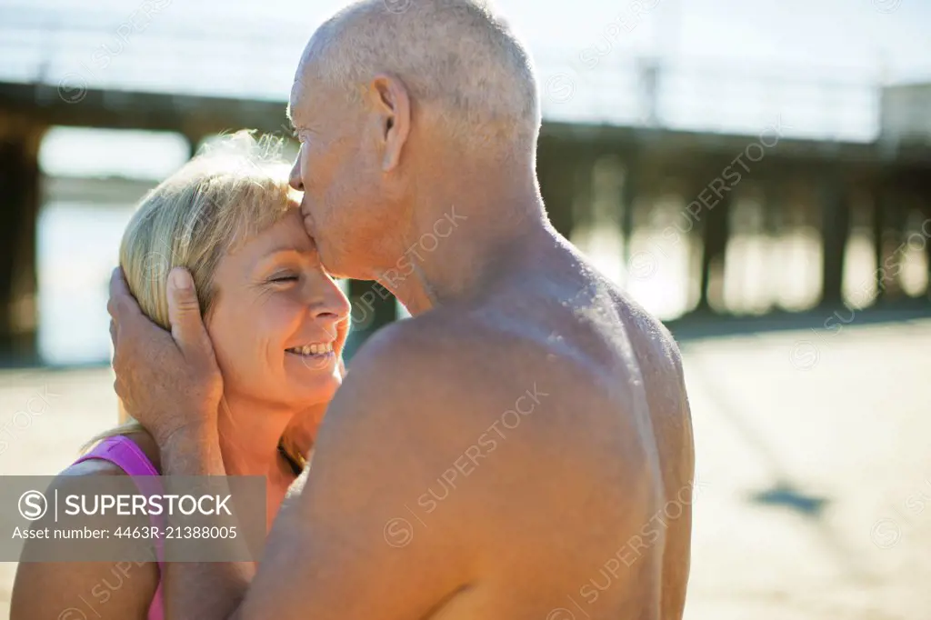 Senior couple embracing on a beach.