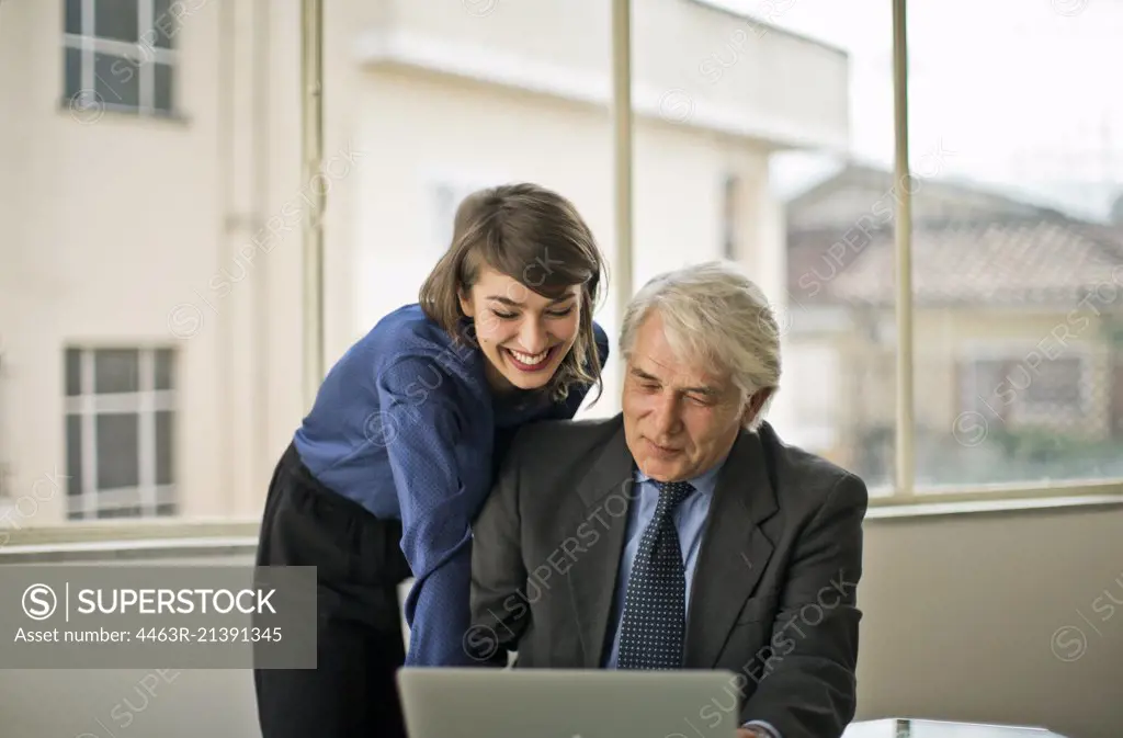 Young businesswoman working in a meeting with her boss.