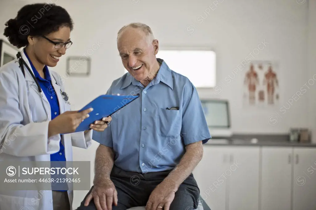 Smiling senior man receiving good news at his annual medical check up.