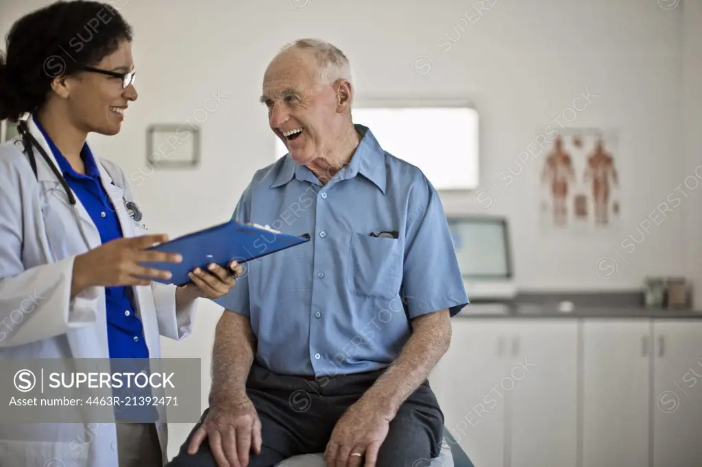 Smiling senior man receiving good news at his annual medical check up.