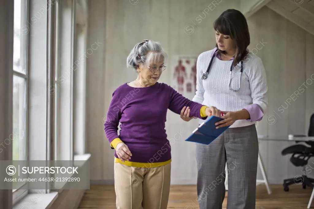 Elderly woman at a medical check-up with her doctor.