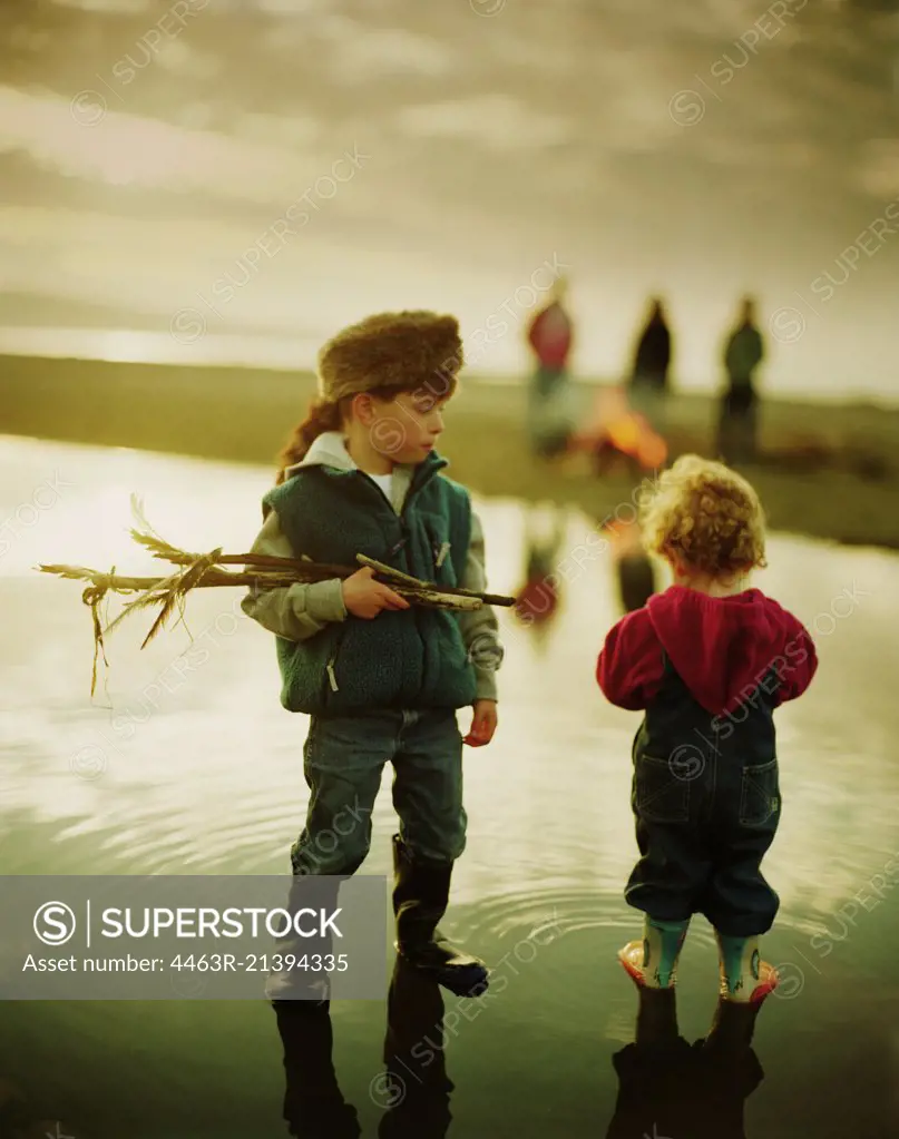 Brothers standing in water