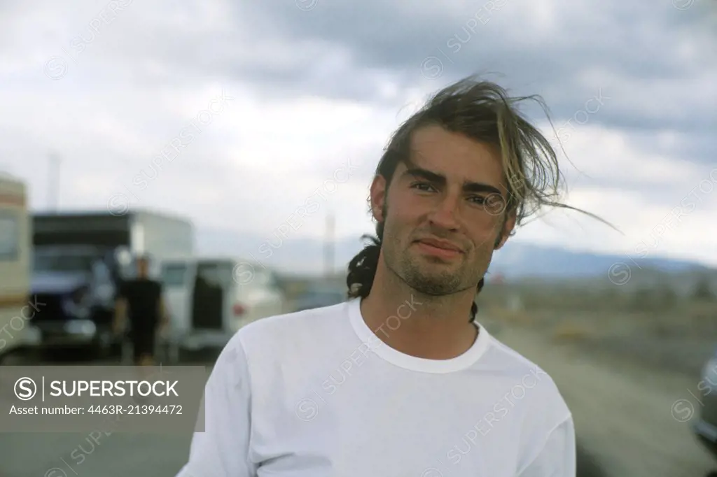 A young man smiling at the camera.