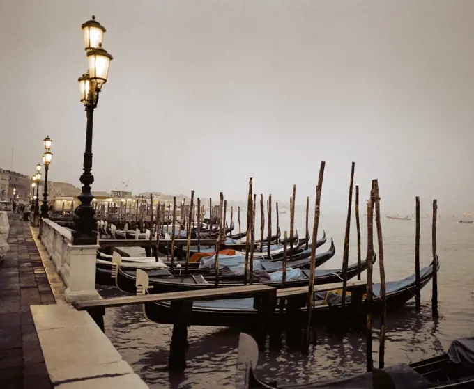 Gondolas moored at a waterfront, Venice, Italy.