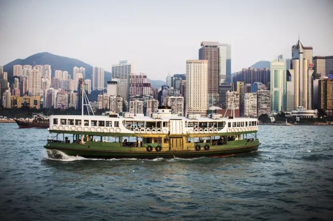 Ferry crossing the harbor of a large city.