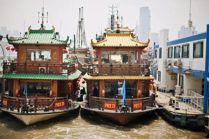 Traditional junk boat moored at a wharf.