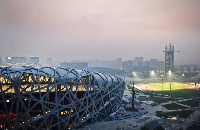 Illuminated sports stadium at night.