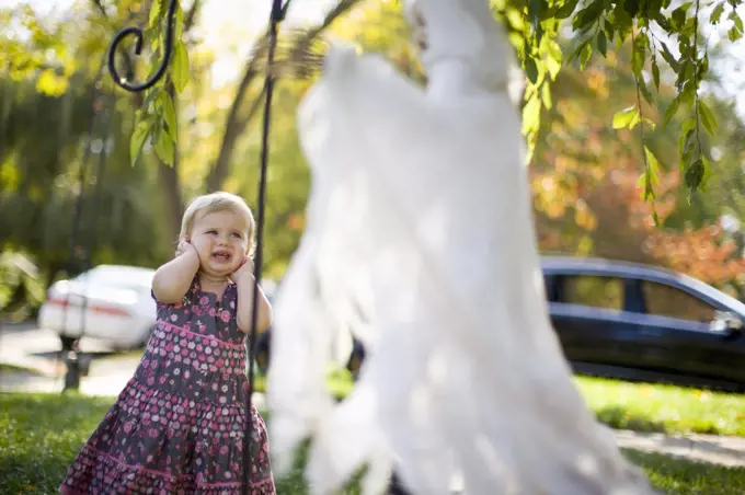 Toddler girl scared by Halloween decoration