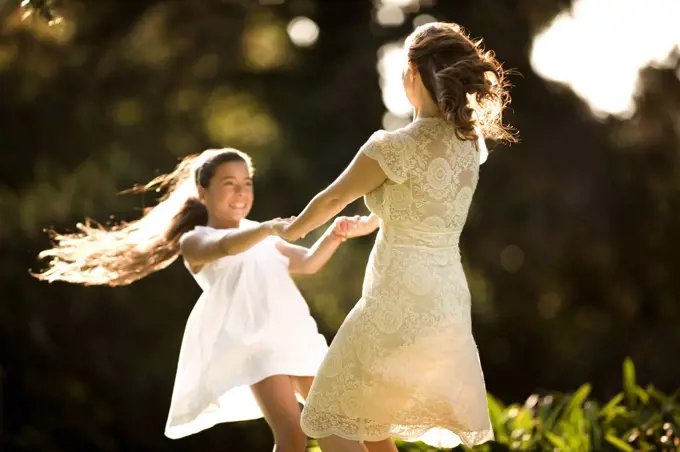 Mother and daughter play Ring a Ring o' Roses.