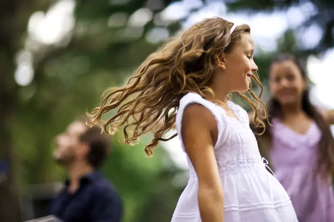 Young girls dancing outdoors.