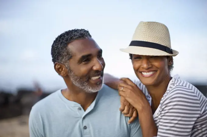 Portrait of mature couple lovingly sitting together.