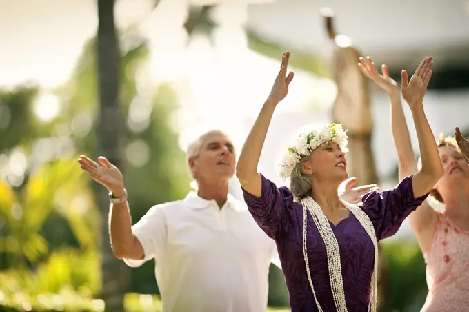 Mature woman teaching the hula dance.