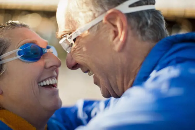 Senior couple embracing on a beach.