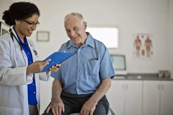 Smiling senior man receiving good news at his annual medical check up.