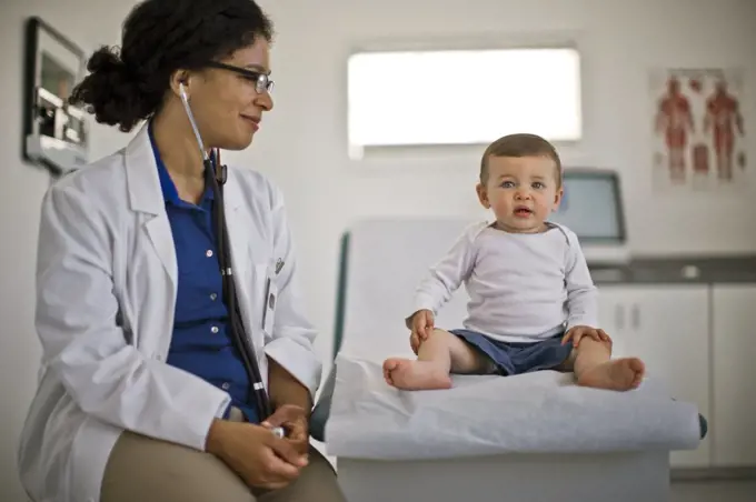 Doctor giving a baby boy a medical check up.