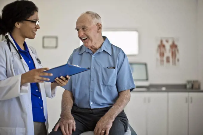 Smiling senior man receiving good news at his annual medical check up.