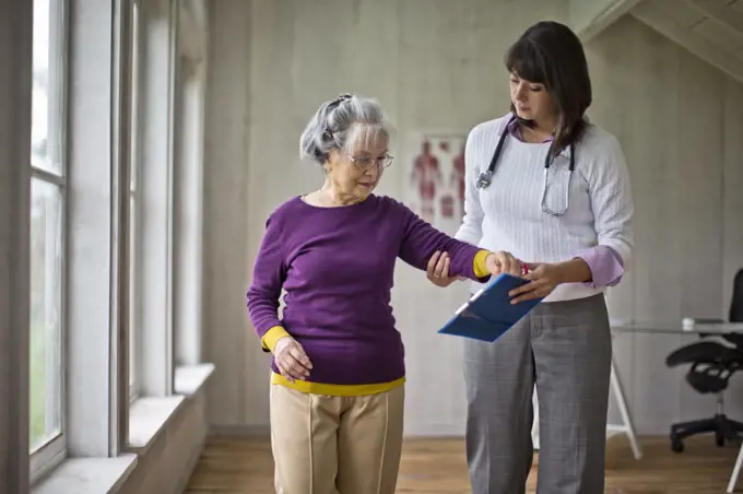 Elderly woman at a medical check-up with her doctor.