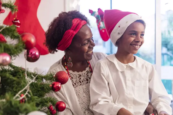 Grandmother opening with her child the christmas gifts