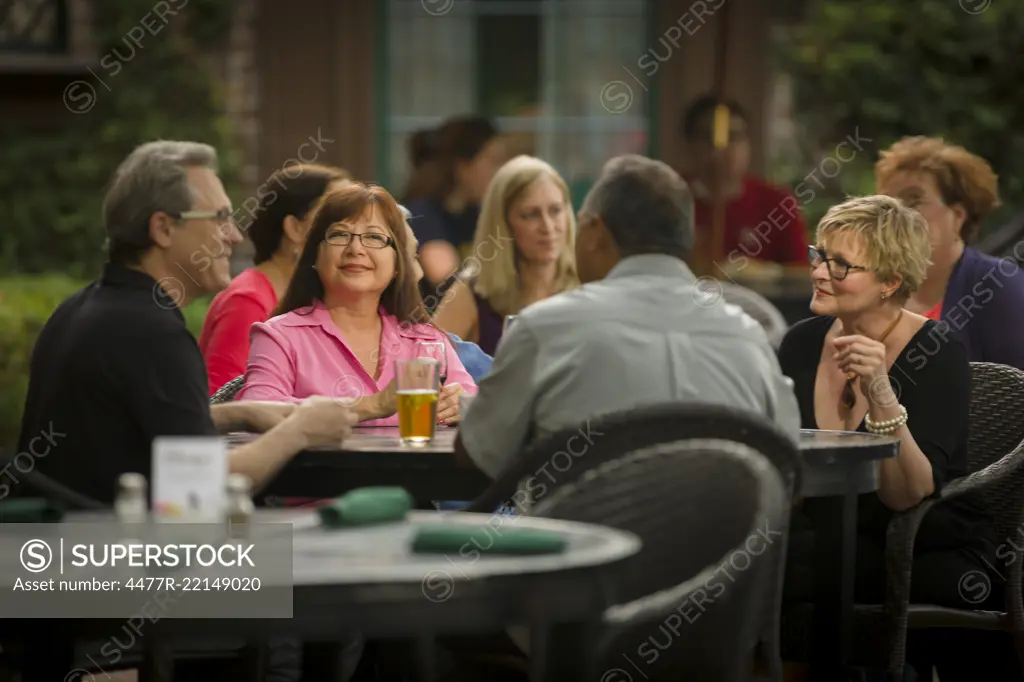 Adults Socializing Over Drinks Outdoors at Pub & Restaurant